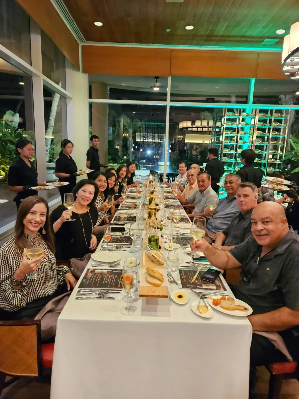 Guests at a long dinner table at the Groth event