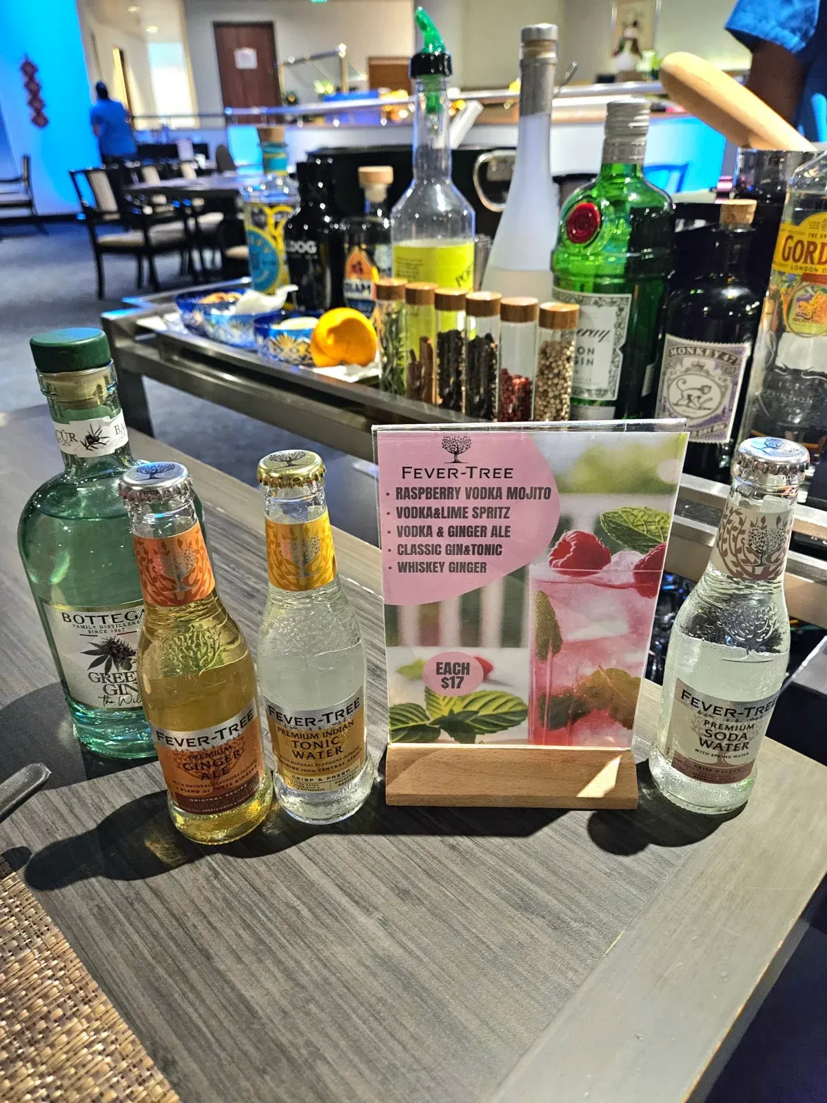 Bottega gin and Fever-Tree mixers on a bar beside a Fever-Tree cocktail menu