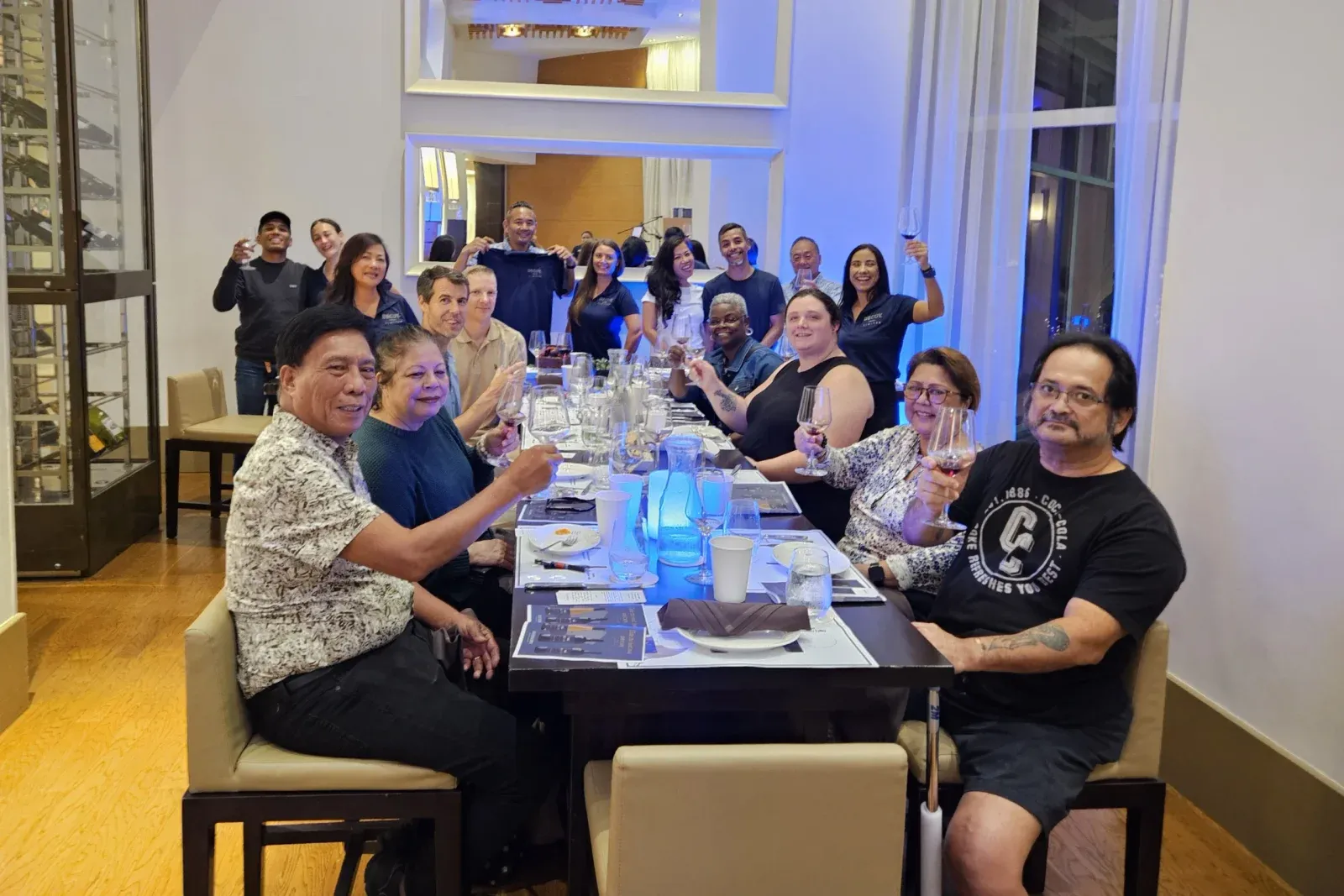 Guests raising their glasses around a table at the Decoy Limited seminar