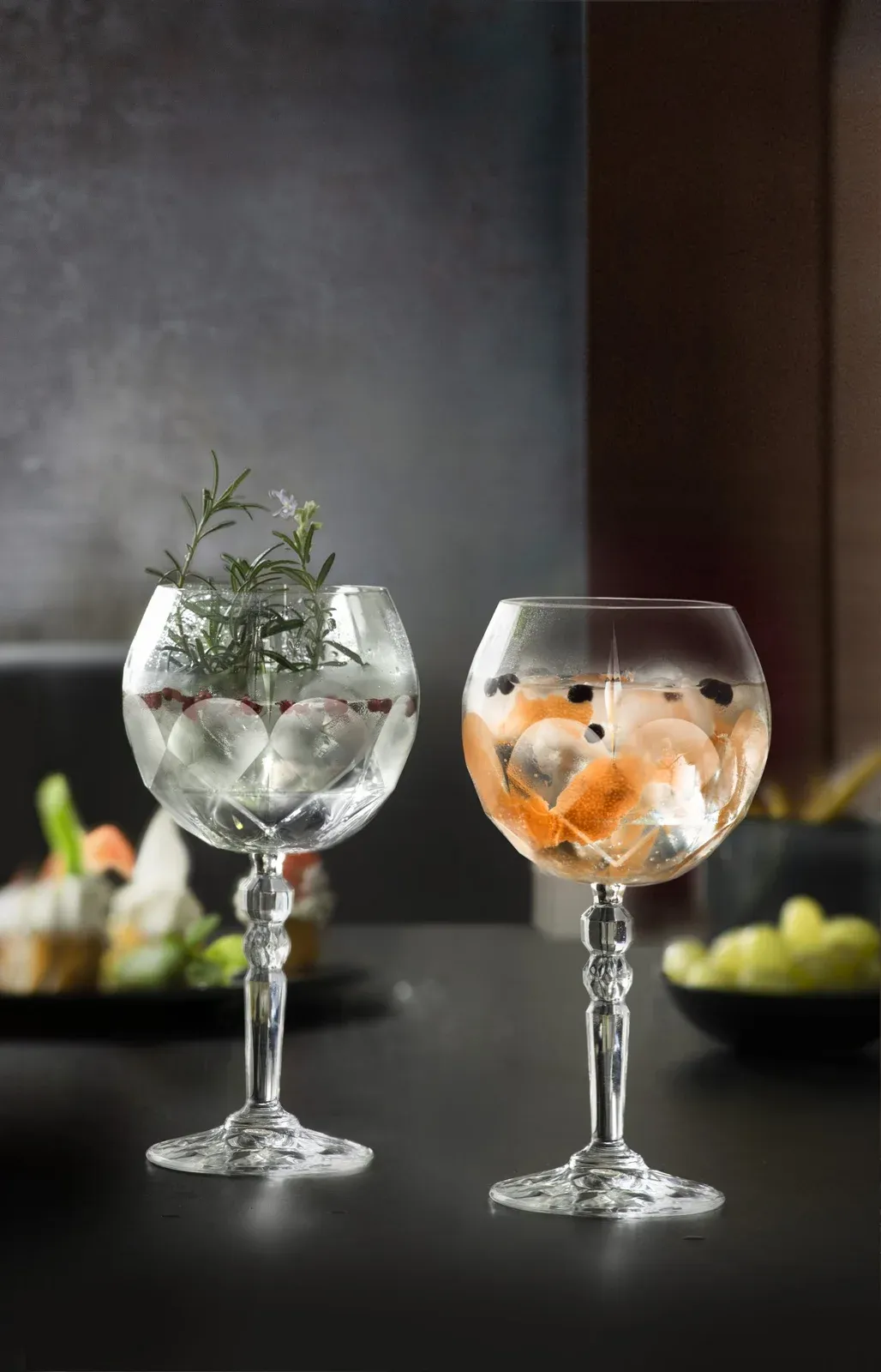 Two gin and tonics in stemmed glasses