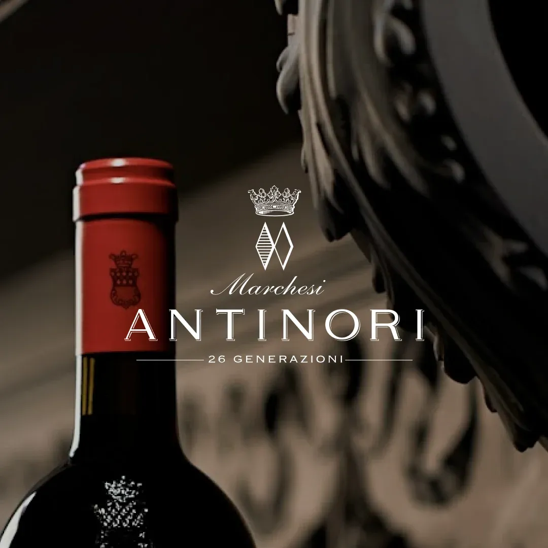 A bottle of Marchesi Antinori wine beside the Antinori crest