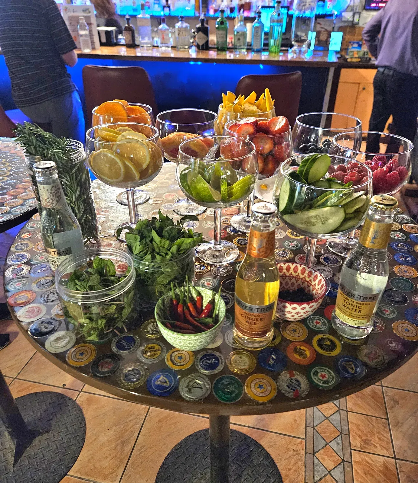 A gin and tonic garnish station with citrus, herbs and Fever-Tree tonic at Biba Bar