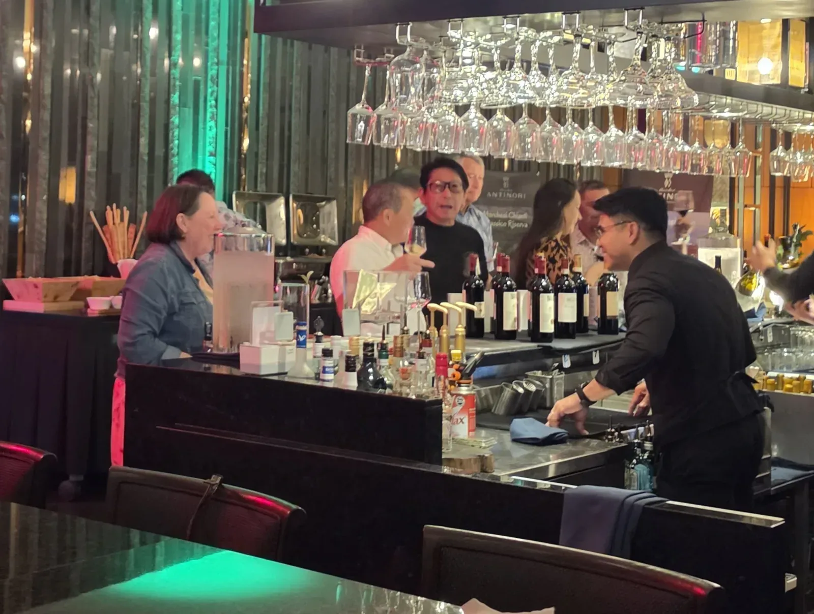 Guests at the La Cantina bar, with Antinori bottles lined up on the counter