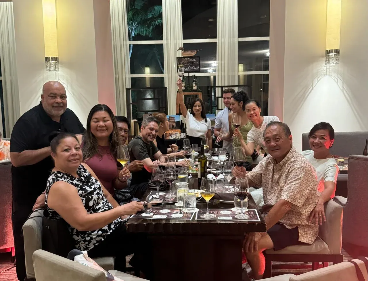 Guests smiling around a table at the Duckhorn wine pairing